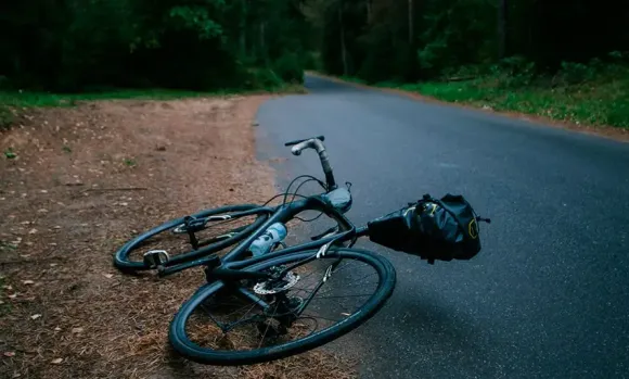 a bicycle lying on the side of the road